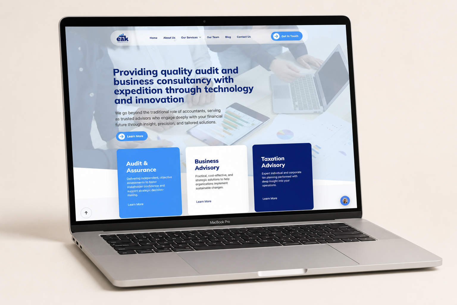 EAK & Associates audit firm website displayed on a MacBook mockup, designed by Amenbiz